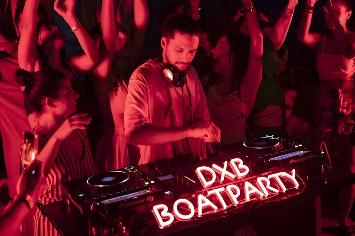 Dance the night away at Dubai's exclusive yacht party where top DJs set the mood amidst a backdrop of stunning sunset views and a lively crowd of party-goers.